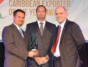 Excellence in Service Exports winner, Nand Persaud Int’l Communications’ Managing Director, Gadhram Ramdial (L); and Guyana Go-Invest Board Member, Owen Verwey, (centre) pose with the award, received from Jay Ollivierre Gomez (R).