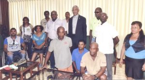 His Excellency President David Granger with members of the William France Differently Abled Athletics Club and France (stooping right) at the Ministry of the Presidency.