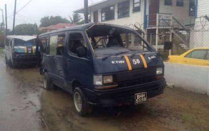 Minibus topples, slams into school bus