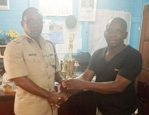 https://www.kaieteurnewsonline.com/images/2017/08/Commander-of-Police-%E2%80%98B%E2%80%99-Division-Assistant-Commissioner-Paul-Williams-presents-one-of-the-trophies-to-Brian-Cummings..jpg