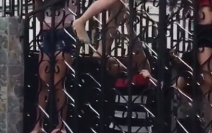 Police raid strip club after video surfaced of woman climbing fence