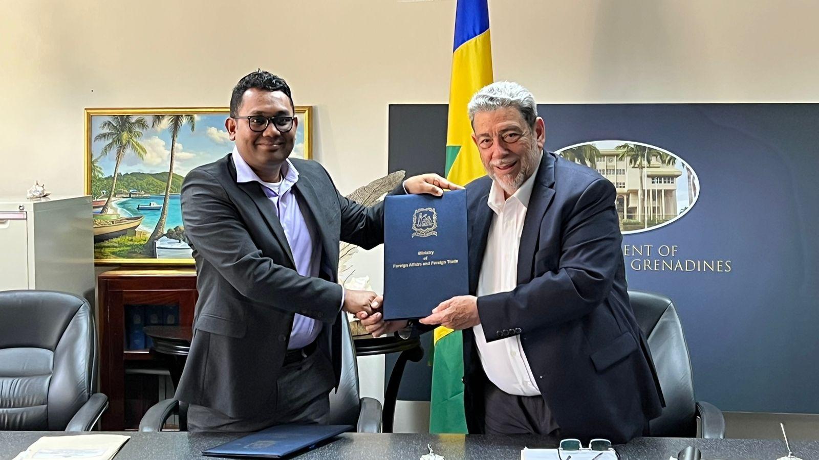 Dowlat Parbhu of Demerara Bank and Prime Minister of St. Vincent and the Grenadines, Dr. Ralph Gonsalves holding signed copies of the loan agreement.  
