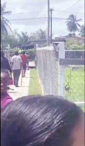 Screengrab taken from the cell phone recorded video of the suspects leaving the school compound with pieces of wood in their hands.