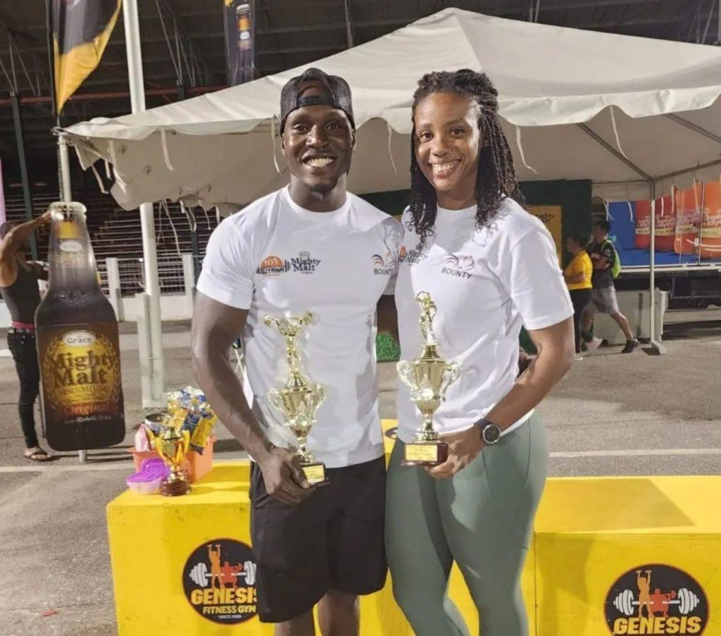 Elite Fitness champs Omisi Williams (left) and Semonica Duke display their prizes. (Newsroom photo)