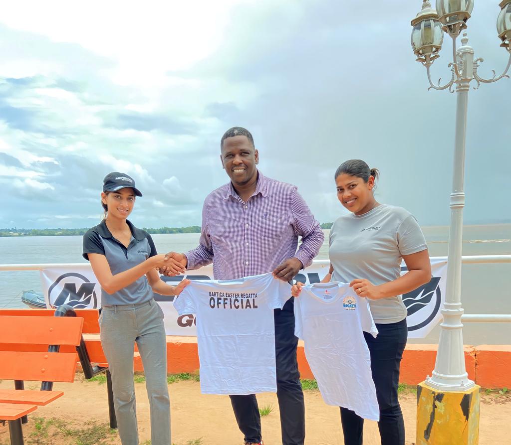 Ms. Sonia Charran, Marine Manager at FARM Supplies Limited hands over one of the tee shirts to Regional Chairman, Kenneth Williams.