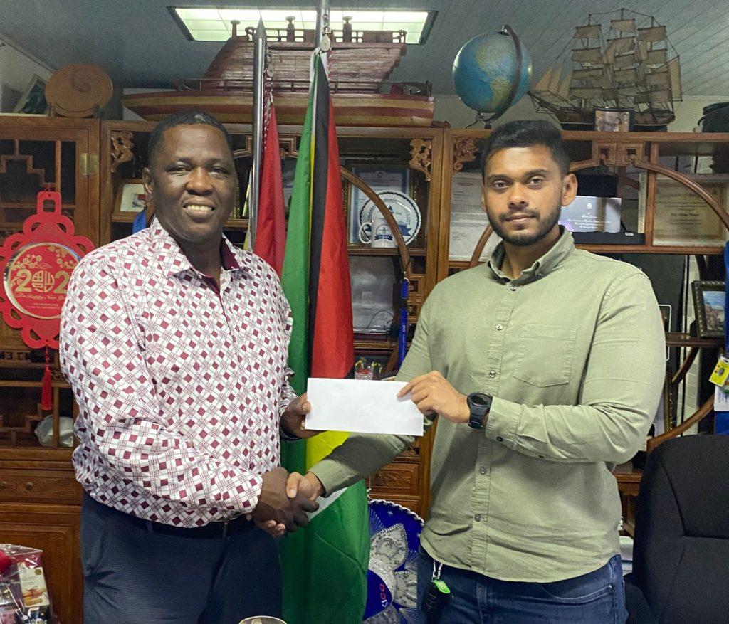 Regional Chairman of Region #7, Kenneth Williams (left) receives the sponsorship cheque from Mr. Kyle Tiwari CEO of the BK Int. Group of Companies.