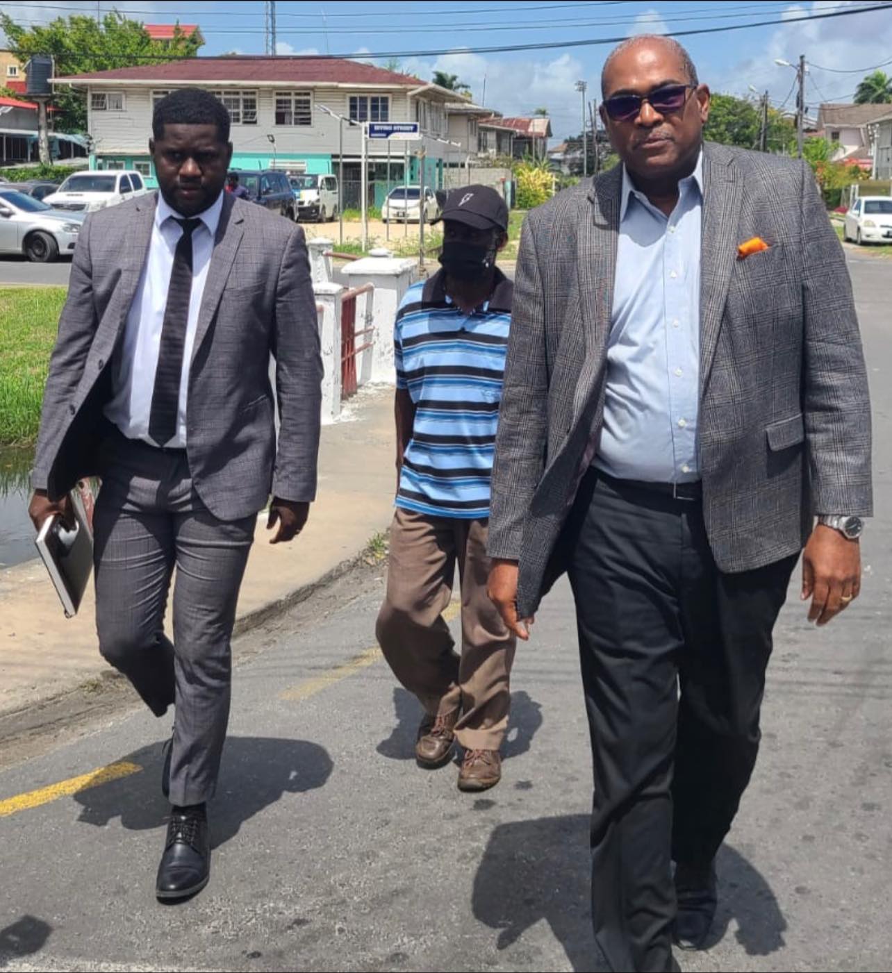 Executive member of the Working People’s Alliance (WPA) Mutope Tacuma Ogunseye turned himself into police investigators on Friday in the presence of his lawyers, Nigel Hughes and Darren Wade. (NewsSource photo)