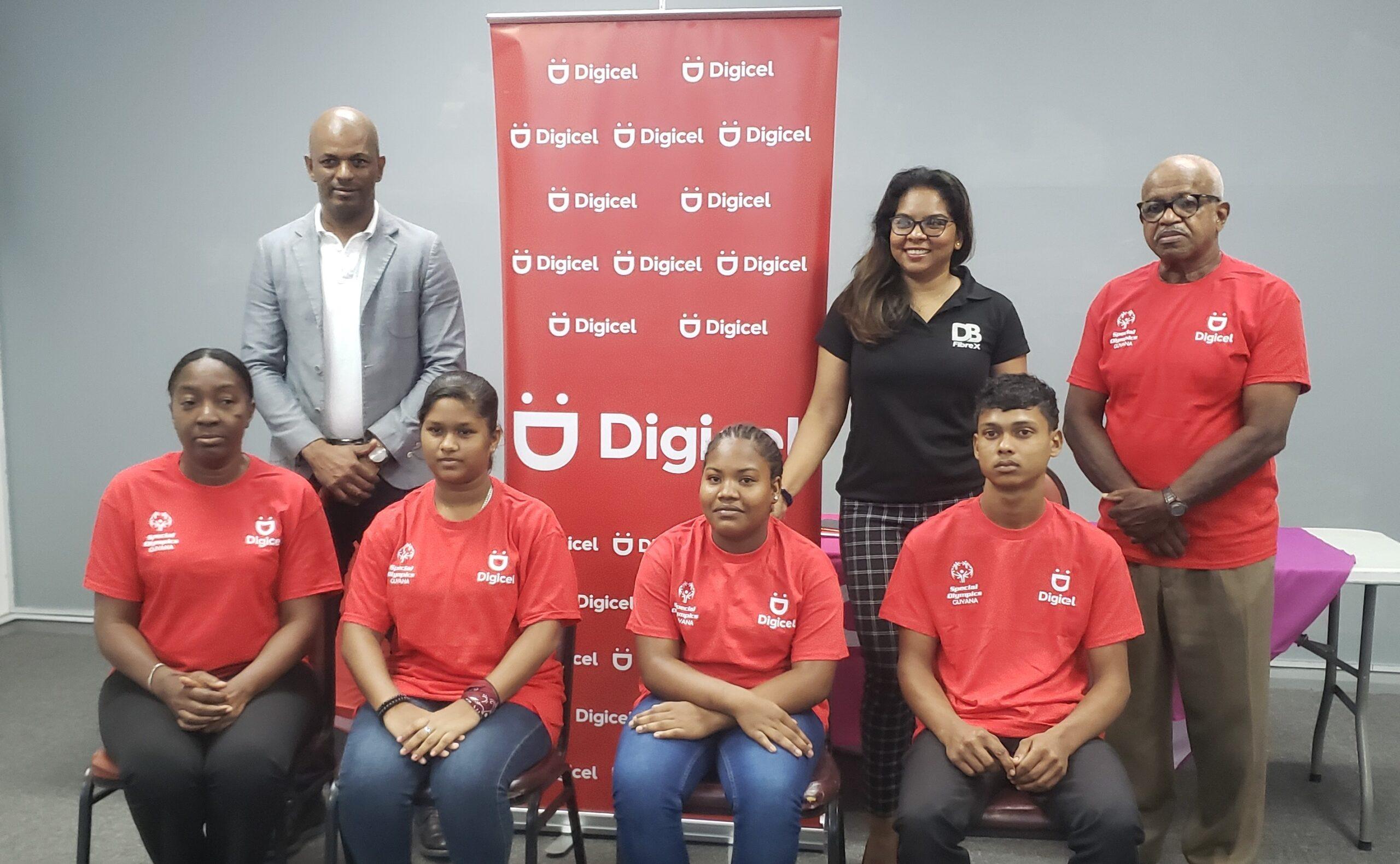 GOA president, Godfrey Munroe, Digicel Guyana Communications Manager, Vidya Sanichara and Wilton Spencer, President of Special Olympics Guyana along with some athletes and coach.