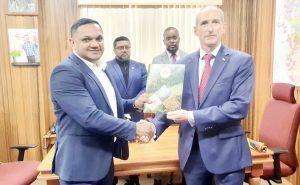 Minister of Natural Resources, Vickram Bharrat hands over the approved Local Content Annual Plan to President of ExxonMobil Guyana, Alistair Routledge. The men are joined in the background by Director of the Local Content Secretariat, Dr. Martin Pertab and the ministry’s Legal Officer, Michael Munroe.