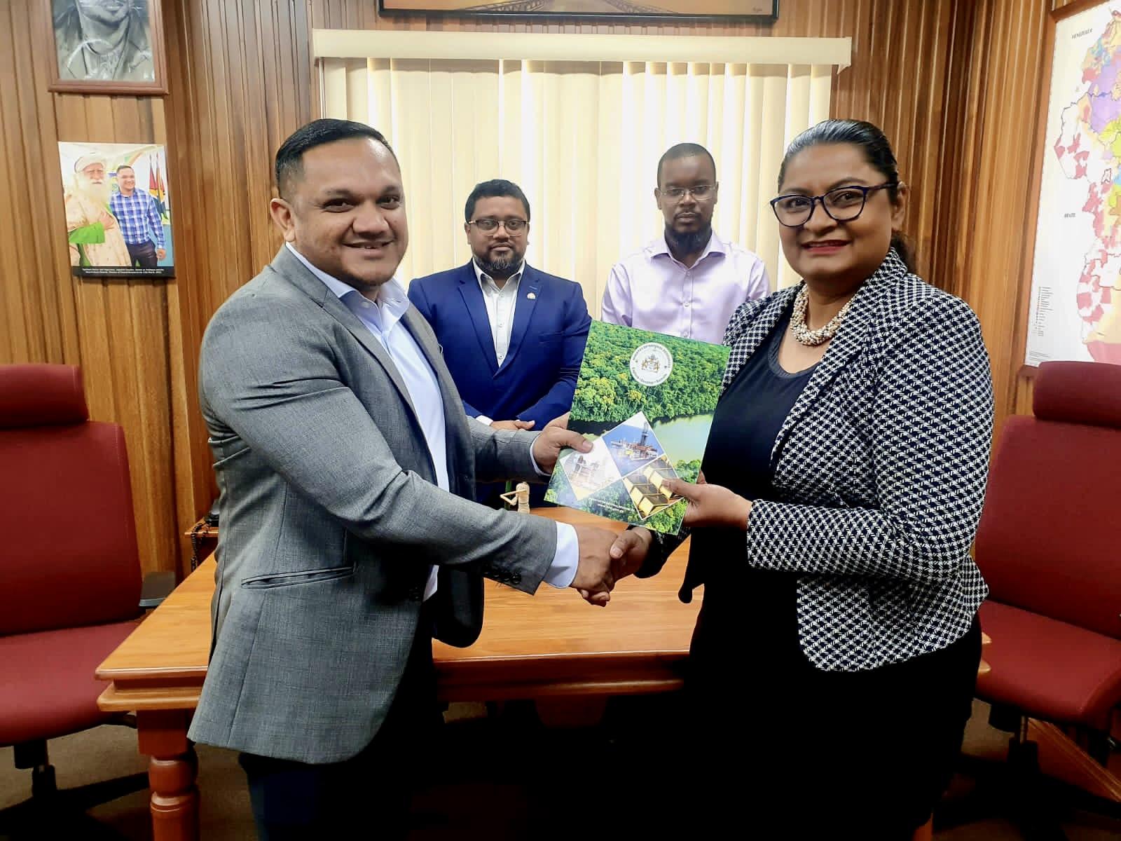 Minister of Natural Resources, Vickram Bharrat, MP., hands over the signed Letter of Approval to SLB’s Managing Director, Ms Sharlene Seegoolam. The men are joined in the background by the Director of the Local Content Secretariat, Dr Martin Pertab and the ministry’s Legal Officer, Mr Michael Munroe.