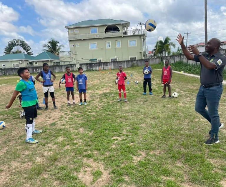 GFF President Wayne Forde engages some of the youngsters during his visit to Bartica.