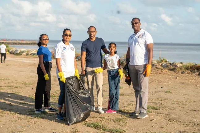 Director General of MARAD, Stephen Thomas, and a family who joined in the cleaning exercise (Photo: DPI)