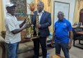 Prime Minister presents champion’s trophy for birth anniversary dominoes tourney to organisers